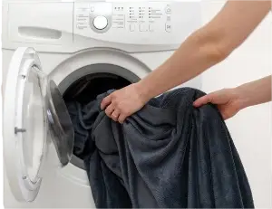 Putting clothes in washer